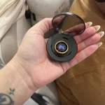 Gen 3 Gold Long Battery Life Smart Ring — open black charging case with a gold ring held in a hand